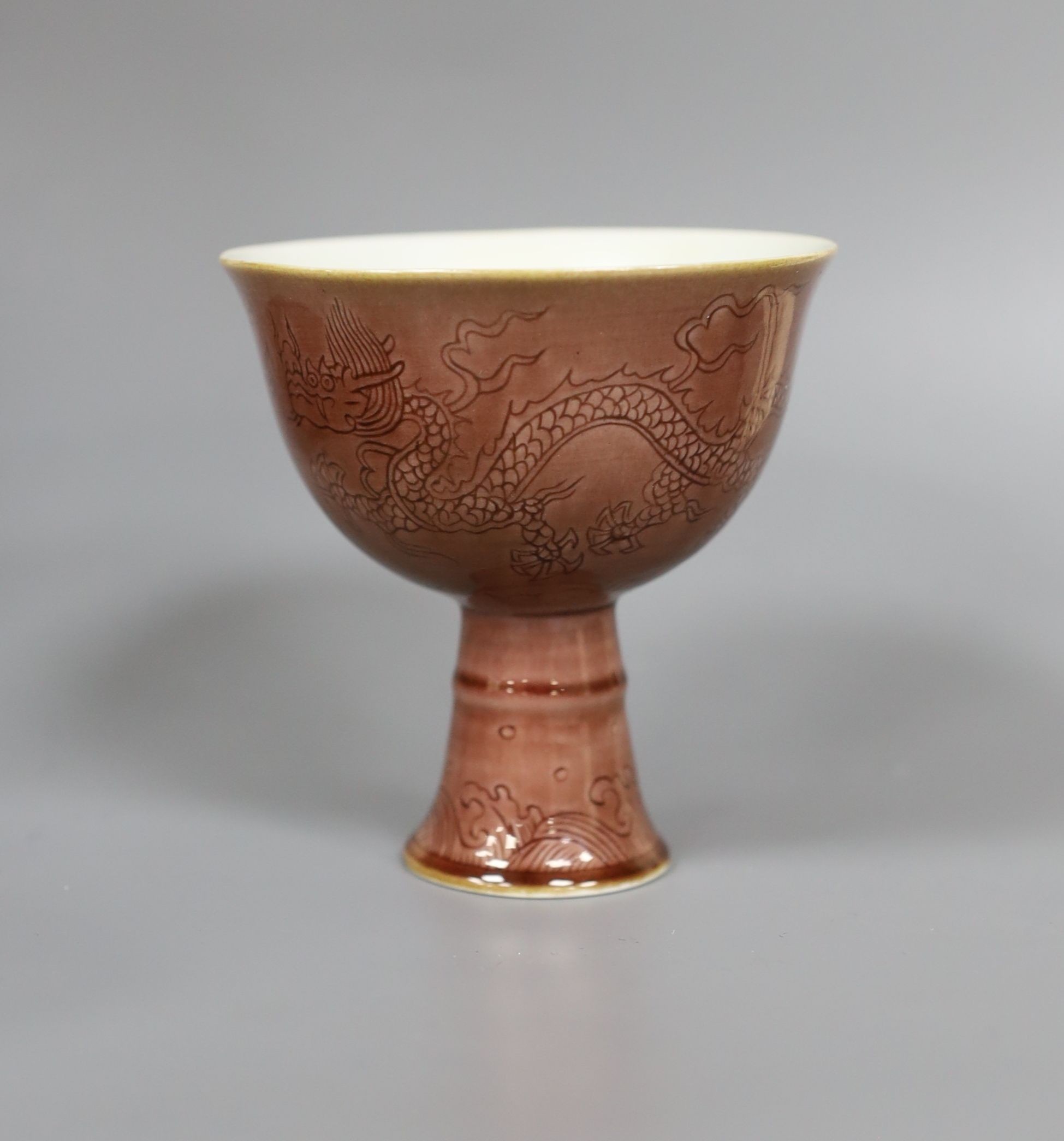 A Chinese cafe au lait glazed saucer, three bowls and a stem cup